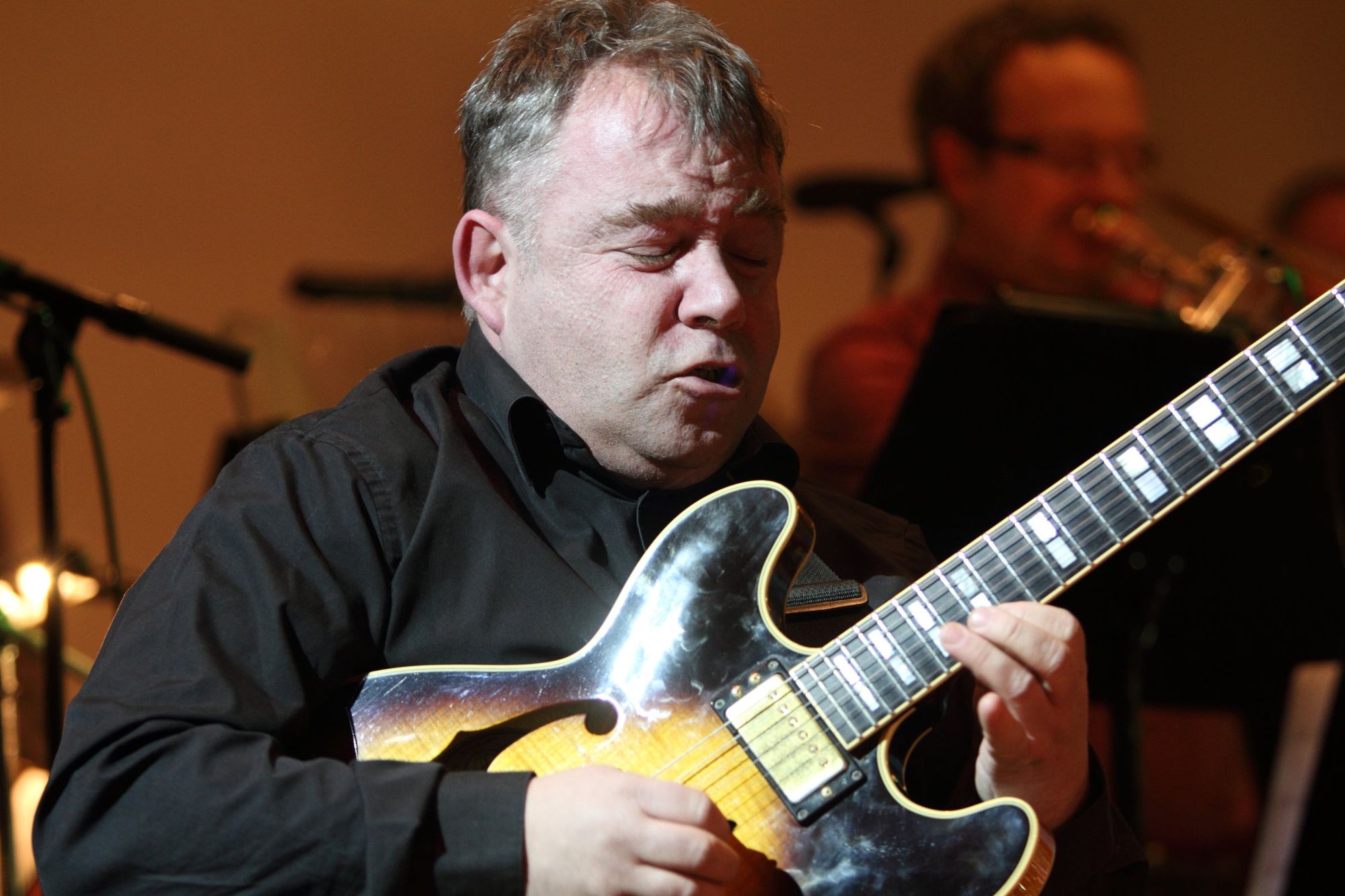 Primož Grašič playing guitar on stage