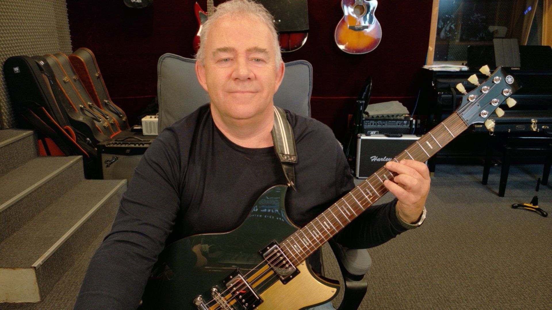 Primož Grašič with a Yamaha guitar in the studio